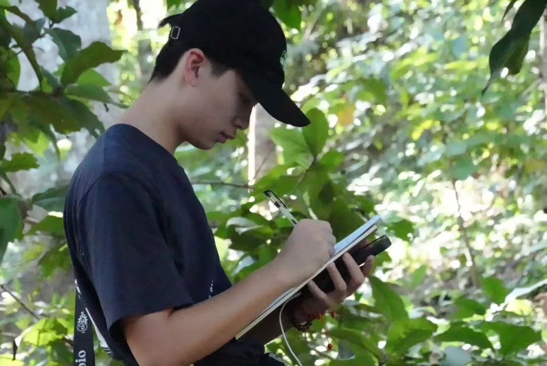 Jacky taking notes in a field notebook in Xishuangbanna.